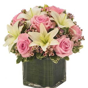 Cube vase arrangement of white lilies, pink roses and pink berries