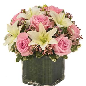 Cube vase arrangement of white lilies, pink roses and pink berries