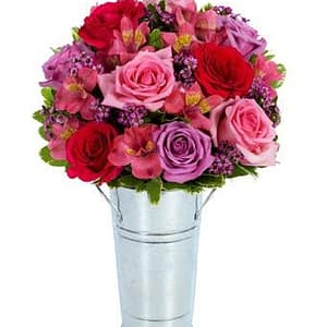 bouquet of red and purple flowers including roses and Peruvian lilies