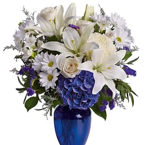 crème roses, white lilies and alstroemeria along with white chrysanthemums, eucalyptus, limonium
