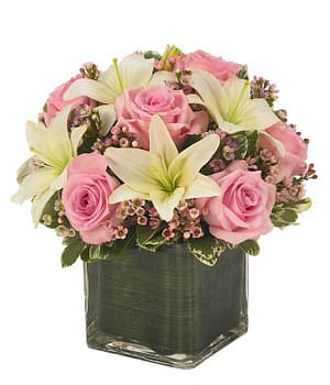 Cube vase arrangement of white lilies, pink roses and pink berries